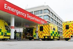 Four yellow emergency ambulances arriving at the A&E